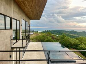 a view from the balcony of a house with a swimming pool at Prime Hermosa- Ocean View Villa with Infinity Pool in Playa Hermosa +22 photos