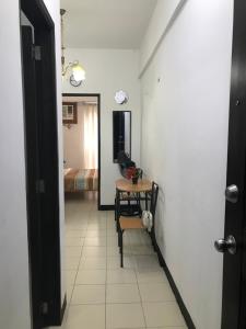 a hallway with a table and a chair in a room at Affordable Studio Unit at Chateau Elysee Lafayette cluster in Manila