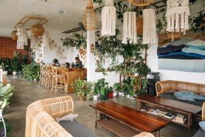 a room with a table and chairs and plants at Mambo Hill Resort in Nusa Penida