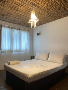 מיטה או מיטות בחדר ב-Boracay Coco Huts