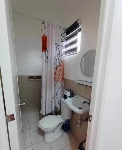 a small bathroom with a toilet and a sink at S&E-2 Tiny Guest House - Olango Island in Lapu Lapu City