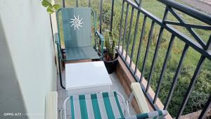 a balcony with a chair and a table at Solace Hide-Out in Ongata Rongai 