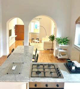 a kitchen and living room with a stove top oven at Susannas Lovely New Apartment in Livorno