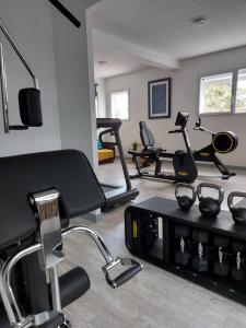 a gym with several exercise equipment in a room at Logis Hotel Relais Saint Jacques - Châteauroux in Déols