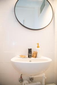 a bathroom with a white sink and a mirror at Cozy City Apartments in center K28 in Vienna