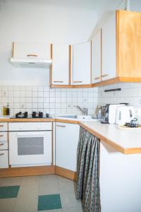 a kitchen with white appliances and wooden cabinets at Cozy City Apartments in center K28 in Vienna