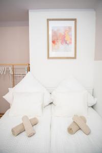 two slippers on a white bed with a picture at Cozy City Apartments in center K28 in Vienna