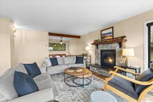 a living room with a couch and a fireplace at Rainbows End Retreat in Hayden