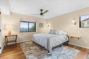 a bedroom with a bed and a table and a window at Rainbows End Retreat in Hayden