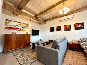 a living room with a couch and a tv at Valgeranna Apartment in Pärnu +9 photos
