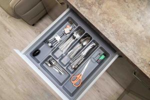 einer Schublade mit Schere und anderen Werkzeugen im Zähler in der Unterkunft Life's a Beach Cottage in Palanga