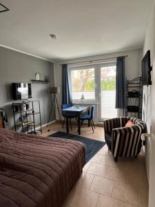 a bedroom with a bed and a table and a chair at Apartment Gartenstrasse 3 in Ostseebad Sellin