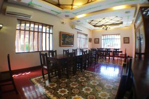 a dining room with a long table and chairs at NSCC Hotel Vigan in Vigan