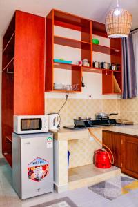 a kitchen with a stove and a microwave at SeaEsta suite 64 Nyali Mombasa in Nyali