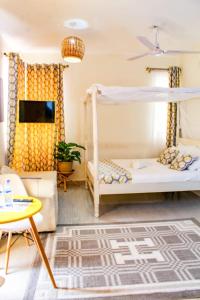 a bedroom with a bunk bed and a couch at SeaEsta suite 64 Nyali Mombasa in Nyali