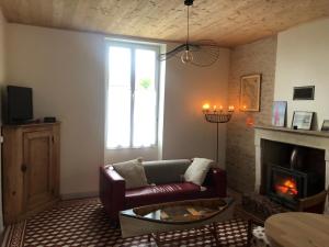 a living room with a couch and a fireplace at La Sirène in Grand-Village-Plage