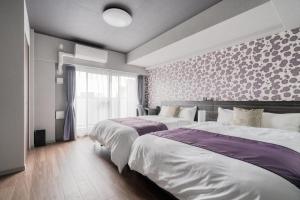 Кровать или кровати в номере BON CONDOMINIUM NAMBA-EBISU - Vacation STAY 7726