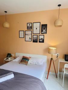 a bedroom with a bed and pictures on the wall at Poetry: Pvt Studio in Koregaon Park . AC WiFi SmartTv in Pune