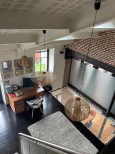 a living room with a couch and a brick wall at Chez Moon in Tiffauges