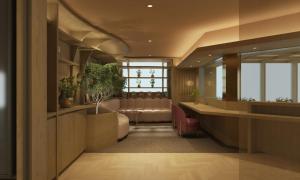 a lobby with a waiting room with leather chairs at Mitsui Garden Hotel Ginza Tsukiji in Tokyo