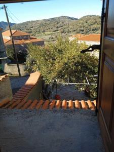 a view from a door of a building with a tree at Stone cottage in Sígrion
