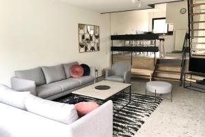 a living room with a couch and a table at De Woning, Wijk de Brabander 109 in Cadzand