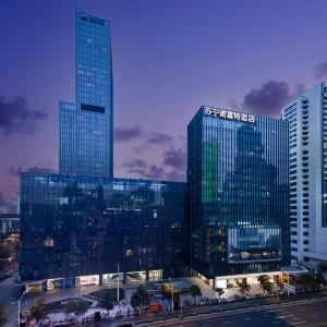 a group of tall buildings in a city at night at Novotel Nanjing Central in Nanjing
