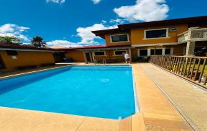 a house with a swimming pool in front of a house at OYO 1068 Villa Adelle At Silang in Maitim