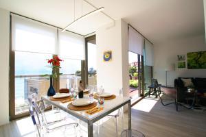 a living room with a table and chairs in a room at Ikhaya Como - Acquaseria, San Siro by LoveComo in Acquaseria
