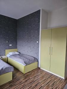 a bedroom with a bed and a cabinet in it at Apart in Radomsko