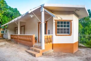 a small house with a porch at Eleven30 Luxury Apartment 1B in Negril