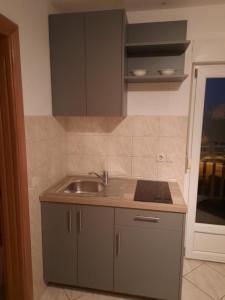 a kitchen with a sink and a counter top at Apartmani I+J Miletic in Vodice