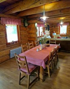 a dining room with a table and chairs in a cabin at Srub Losiny in Velké Losiny