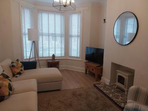 a living room with a couch and a mirror at 47 Elmville Avenue in Scarborough