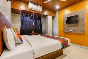 a bedroom with a bed and a tv in it at FabExpress Yatri Inn in Turambhe