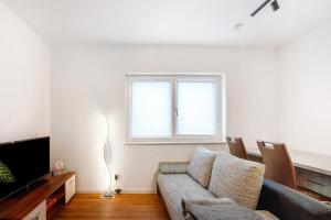 un salon avec un canapé et une télévision dans l'établissement Ferienwohnung auf dem Land, à Apfeldorf