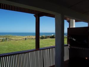 a screened in porch with a view of the ocean at El Olvido in La Paloma