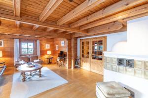 a living room with wooden walls and a wooden ceiling at Allgäu Nest in Bad Hindelang