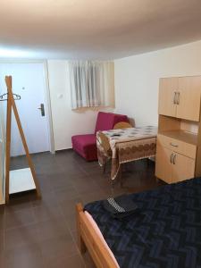 a room with a bed and a table and a chair at Cozy apartment for short term rent. in Káty