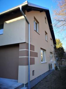 a building with a light pole in front of it at Cozy apartment for short term rent. in Káty