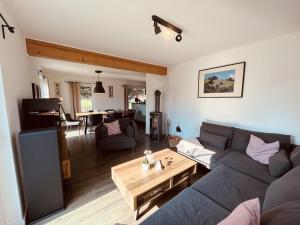 a living room with a couch and a table at Ferienhaus De niege Leive in Born