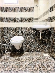 a bathroom with a toilet and a sink at Hotel Kutch Palace in Bhuj