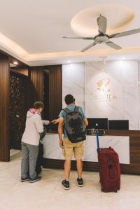 a man and a woman standing in a hotel lobby at Tamcoc Catalina Hotel in Ninh Binh
