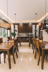 a dining room with wooden tables and chairs at Tamcoc Catalina Hotel in Ninh Binh