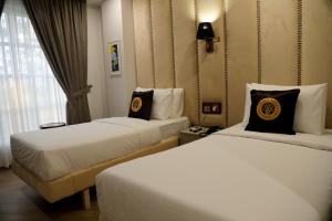 a hotel room with two beds and a window at THREE TREE Signature Hotel - G7 Markaz Islamabad in Islamabad