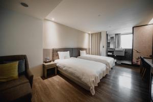 Postel nebo postele na pokoji v ubytování Hub Hotel Kaohsiung Yawan Branch