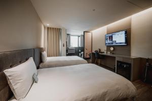 Postel nebo postele na pokoji v ubytování Hub Hotel Kaohsiung Yawan Branch