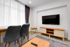 a living room with two chairs and a flat screen tv at Cozy Flat 10 min to Marmaray and Uskudar Coast in Istanbul