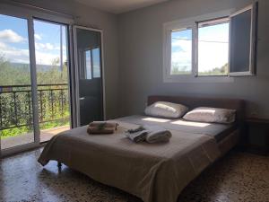 a bedroom with a bed with two towels on it at Beautiful Farm House in Filiatra
