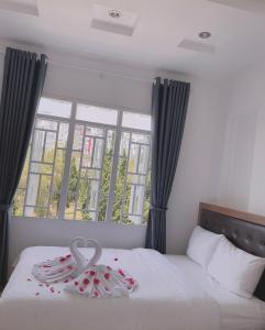 a bedroom with a bed with a swan decoration on it at Phuong Vy Hotel in Da Lat